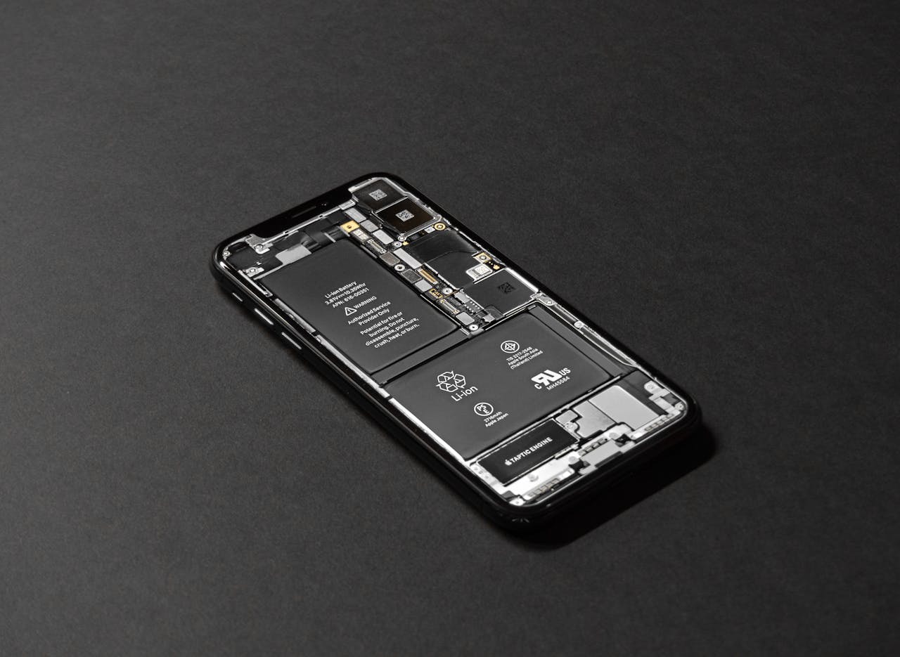 Home High-resolution image of a smartphone showcasing its internal components on a dark surface.